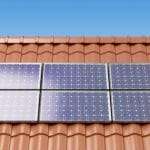 Solar panels on the roof of a house, producing electricity